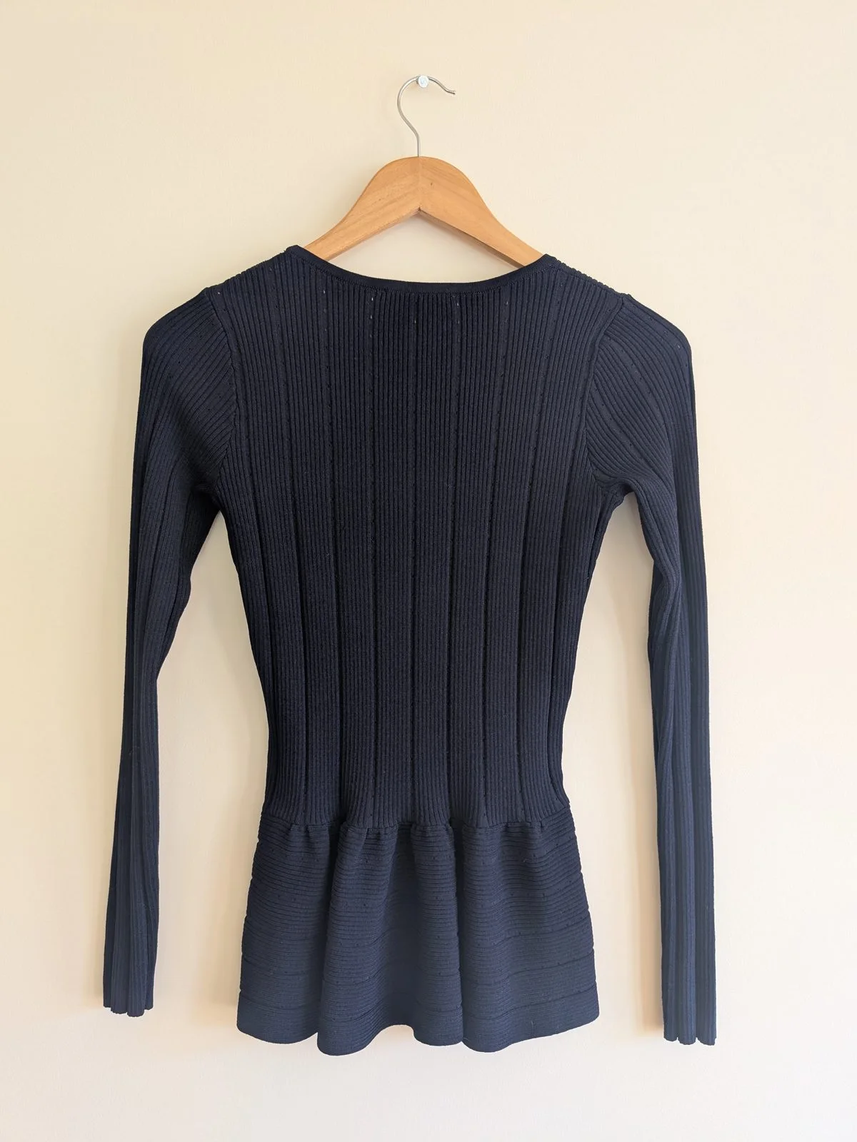 Back view of the navy SANDRO ribbed knit peplum top