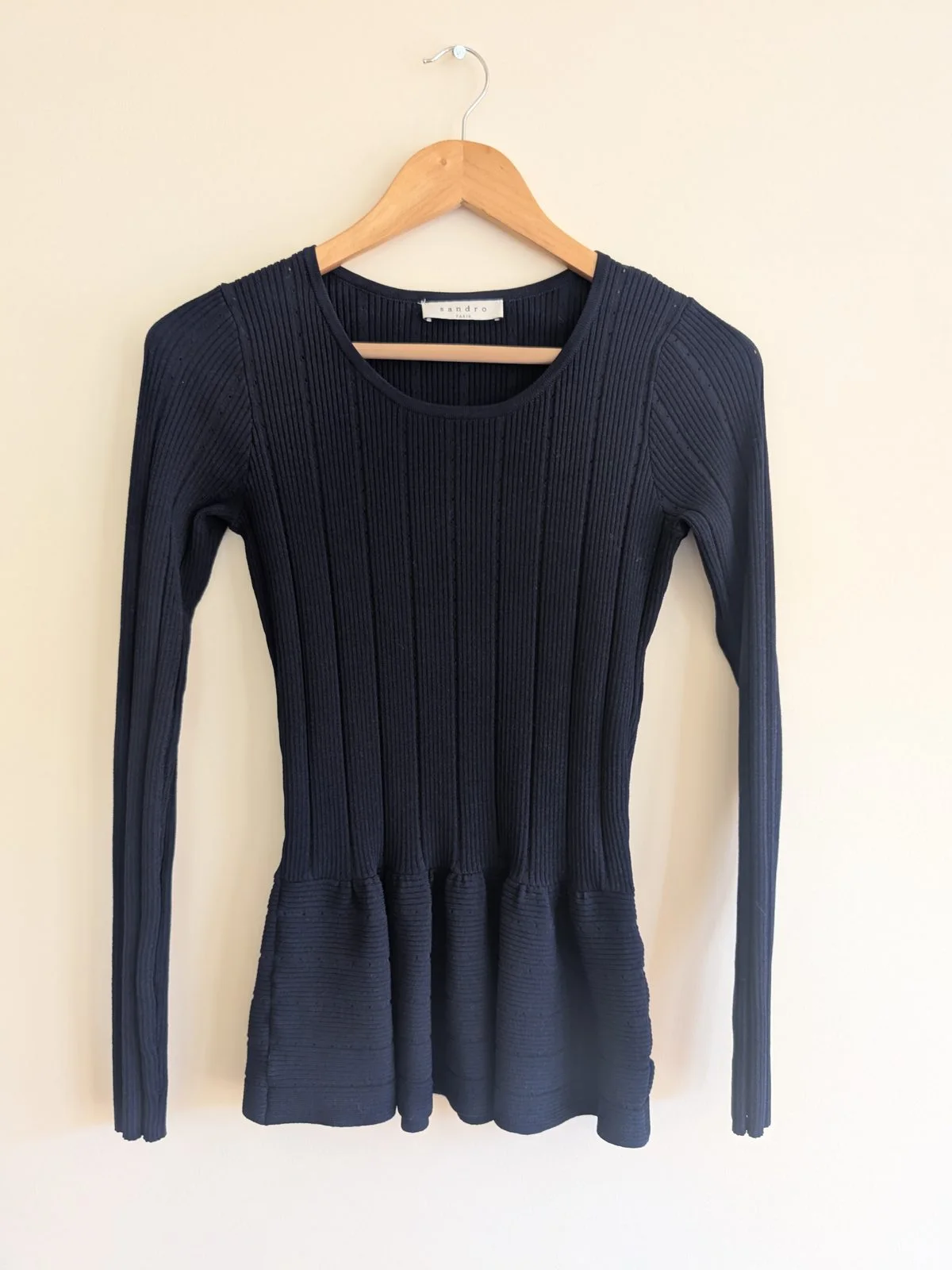 Front view of the navy SANDRO ribbed knit peplum top