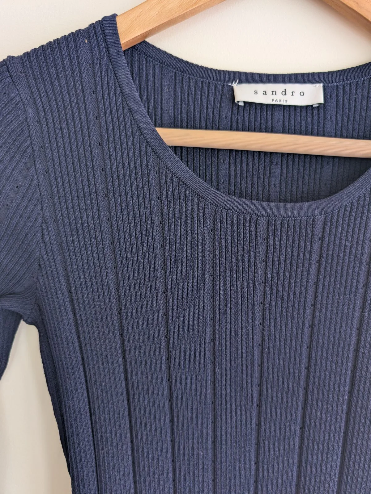 Close view of the neckline and ribbed knit texture
